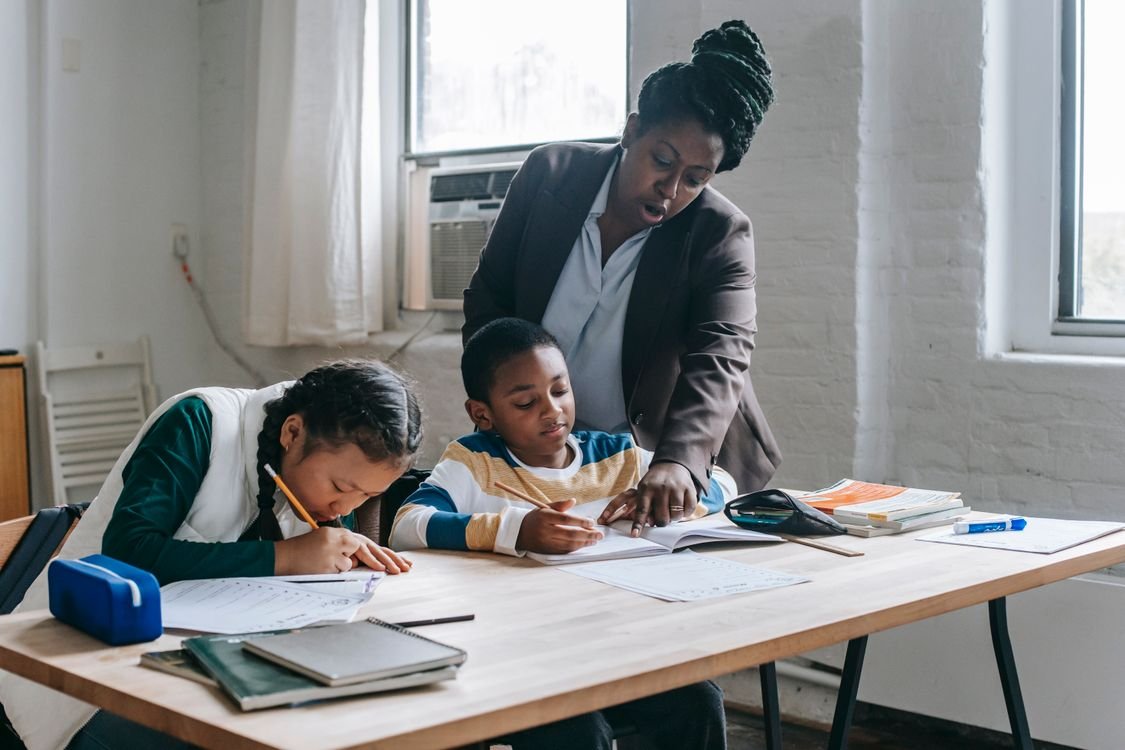 A teacher helping pupils with their schoolwork